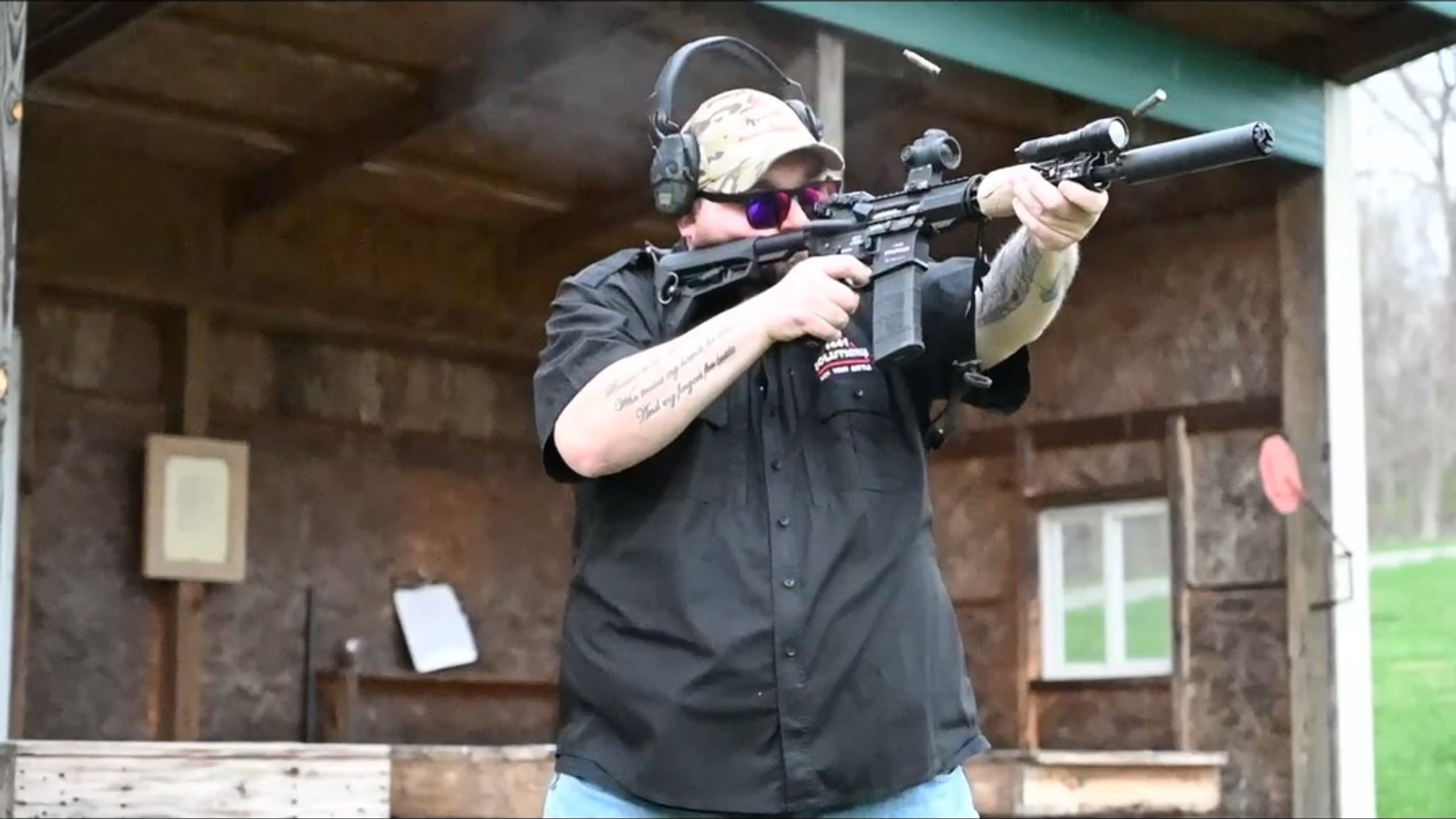 1441 Solutions firearms instructor firing a rifle at an outdoor shooting range
